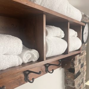 CC-1-09 - Club Car plush bath towels stacked on wood shelf next to original heritage chimney with clock