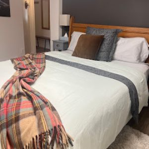 CC-02-06 - Ocean 2nd Bedroom features premium linens and heritage plaid throw, creating a calm and restful atmosphere