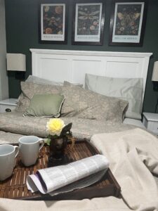 STA-04-08 - The elegant and plush queen bed in the Garden Suite at Saltair Station, featuring luxury linens and a cozy, heritage-inspired atmosphere